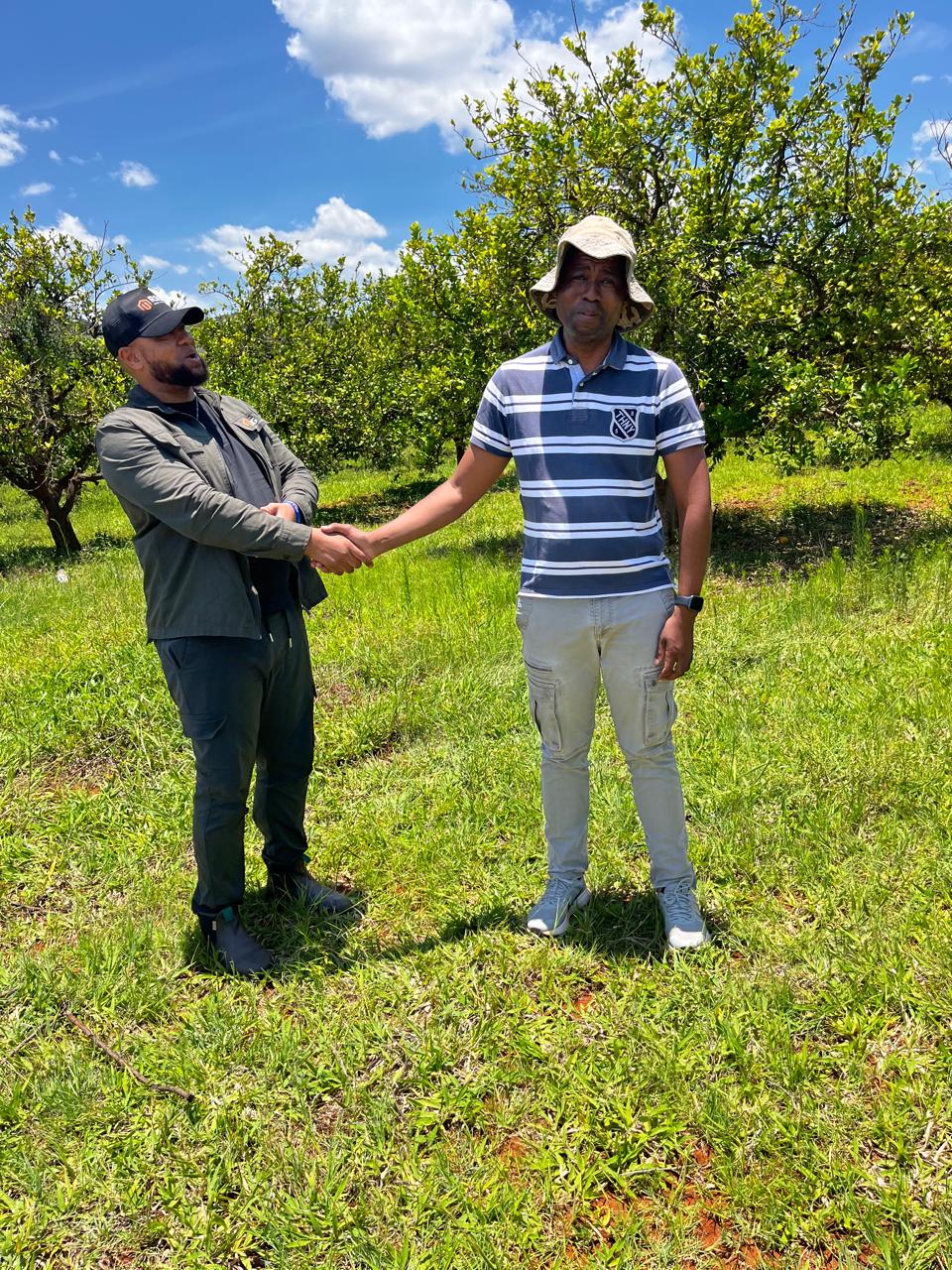 Kabelo Letsoalo and Matome Letsoalo shaking hands on a DRC farm